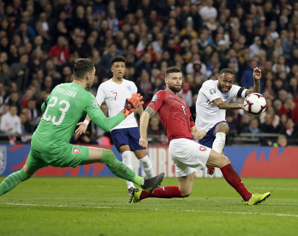 England's Raheem Sterling, right, scores his side's third goal during the Euro 2020 group A qualifying soccer match between England and the Czech Republic at Wembley stadium in London, Friday March 22, 2019. (AP Photo/Tim Ireland)