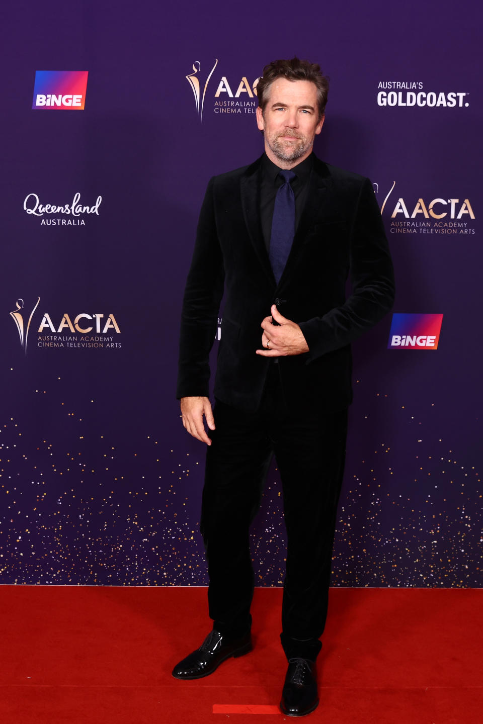 Patrick Brammall matched with his wife on the carpet. Photo: Getty