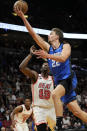 Orlando Magic forward Franz Wagner (22) drives to the basket as Miami Heat center Bam Adebayo (13) defends during the first half of an NBA basketball game, Friday, Jan. 27, 2023, in Miami. (AP Photo/Lynne Sladky)