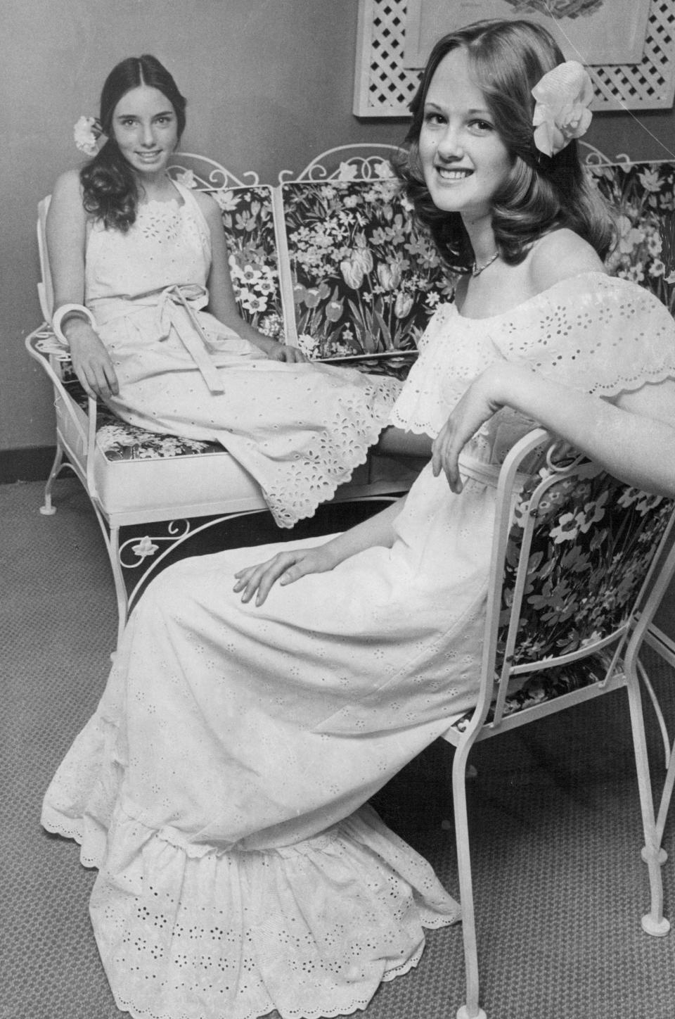 Two girls wearing white prom dresses in 1977