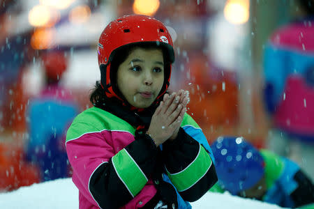 A Saudi girl enjoys snow in the new Snow City at Al Othaim Mall in Riyadh, Saudi Arabia July 26, 2016. Picture taken July 26, 2016. REUTERS/Faisal Al Nasser