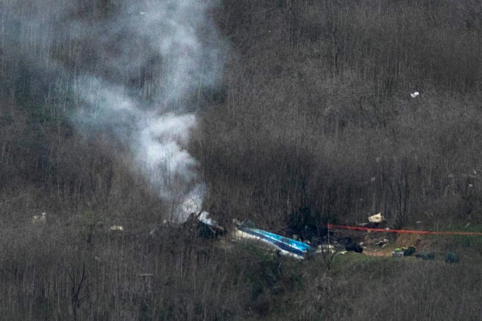 Wreckage of the crashed helicopter that was carrying former NBA star Kobe Bryant and his 13-year-old daughter Gianna smolders on the ground on January 26, 2020 in Calabasas, California. (Getty Images)