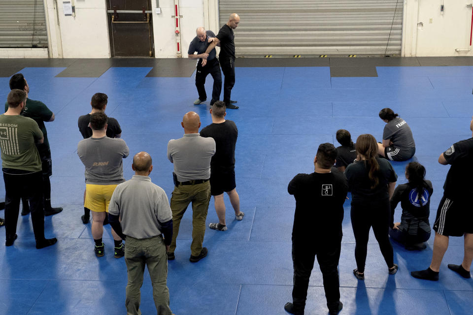 With the help of a student, Instructor Dave Rose, top left, demonstrates a control technique during an Arrest & Control Instructor course in Sacramento, Calif., on Thursday, Jan. 18, 2024. Law enforcement officers from various agencies attend the class where they receive instruction on basic techniques of arrest and control that they to take back to their agencies to pass along to fellow officers. (AP Photo/Rich Pedroncelli)