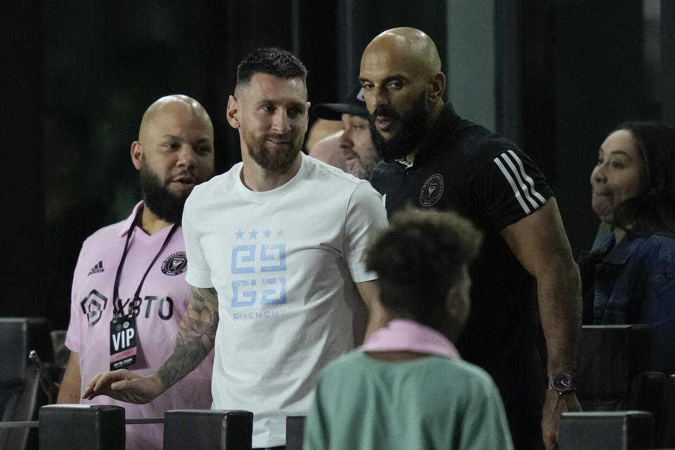 Inter Miami forward Lionel Messi, center left, greets a young fan at the end of an MLS soccer match between Inter Miami and Charlotte FC, Wednesday, Oct. 18, 2023, in Fort Lauderdale, Fla. (AP Photo/Rebecca Blackwell)