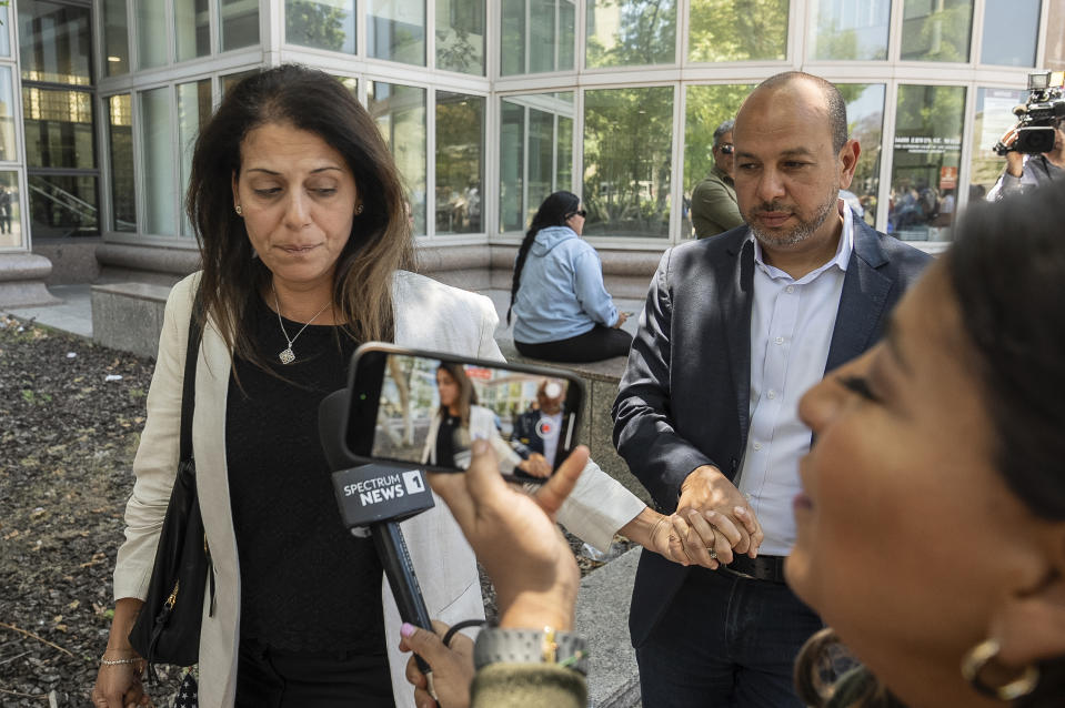 Nancy Iskander, left, holding the hand of her husband, Karim, leaves Van Nuys Courthouse on Monday, June 10, 2024, in Van Nuys, Calif., after attending the sentencing hearing in the murder trial of Rebecca Grossman, who is charged in the deaths of their two sons, Mark, 11, and Jacob, 8. Grossman was sentenced Monday to 15 years to life in prison for the hit-and-run deaths of the two young brothers in a crosswalk. (AP Photo/Damian Dovarganes)