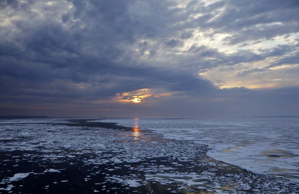 The sun sets over melting sea ice on Peel Sound along the Northwest Passage in the Canadian Arctic Archipelago on July 23. (Photo: David Goldman/AP)