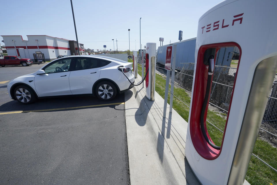 A Tesla charges at a station in Topeka, Kan., Monday, April 5, 2021. The president and the auto industry maintain the nation is on the cusp of a gigantic shift to electric vehicles and away from liquid-fueled cars, but biofuels producers and some of their supporters in Congress aren’t buying it. They argue the U.S. should increase sales of ethanol and biodiesel, not abandon them. (AP Photo/Orlin Wagner)