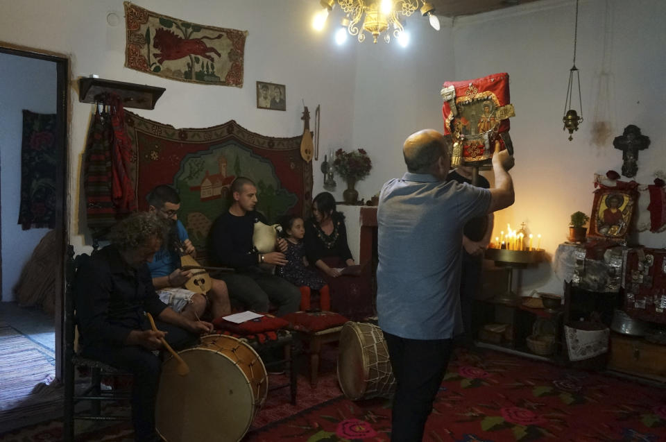 Sotirios Gkaintatzis, center, dances carrying an icon in honor of St. Constantine in the special room reserved for the saint's feast in Lagkadas, Greece, on Monday, May 22, 2023. Gkaintatzis, the leader of this group of devotees called "anastenaria," raptly danced to traditional drum, lyra and bagpipe music unique to these celebrations held only in a few villages in northern Greece. (AP Photo/Giovanna Dell'Orto)