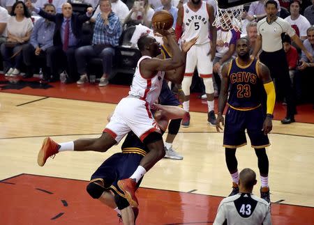 May 23, 2016; Toronto, Ontario, CAN; Toronto Raptors center Bismack Biyombo (8) shoots for a basket and is fouled by Cleveland Cavaliers forward Kevin Love (0) in game four of the Eastern conference finals of the NBA Playoffs at Air Canada Centre. Mandatory Credit: Dan Hamilton-USA TODAY Sports