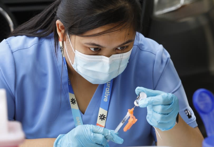 LOS ANGELES, CA - JULY 23: Registered Nurse Julie Anne Buenaventura prepares doses of the Pfizer vaccine at the Pico Union Project Pico Union Project located at 1153 Valencia where Curative is offering Covid testing and a choice of Pfizer or Johnson and Johnson Covid vaccine on Friday morning. We're asking the few that attended what has finally motivated people to get vaccinated. Pico Union Project on Friday, July 23, 2021 in Los Angeles, CA. (Al Seib / Los Angeles Times).