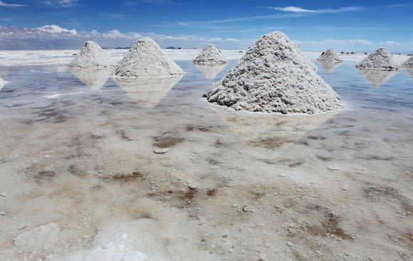 A salt lake with piles of lithium. Blue sky in background.