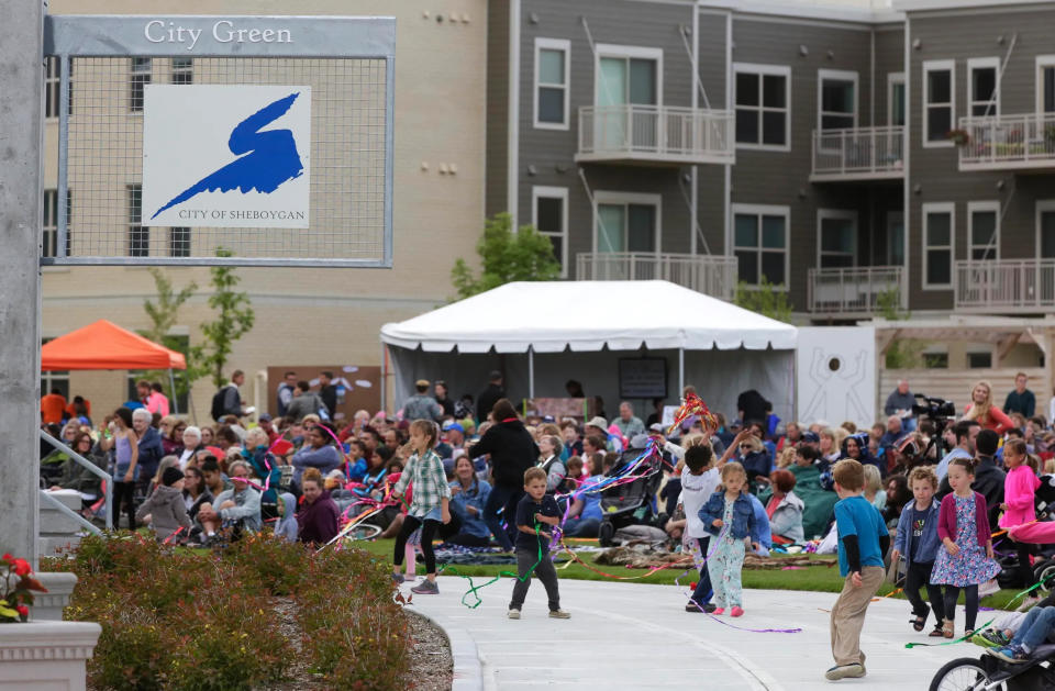 FILE - Children scamper about during the kickoff for Levitt AMP concert series at City Green June 21, 2018, in Sheboygan.