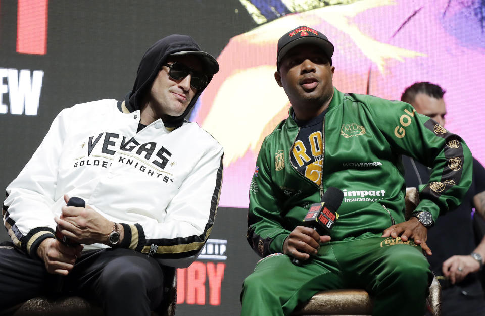 Tyson Fury, of England, left, and his trainer Javon "SugarHill" Steward attend a news conference for Fury's upcoming WBC heavyweight championship boxing match against Deontay Wilder, Wednesday, Feb. 19, 2020, in Las Vegas. (AP Photo/Isaac Brekken)