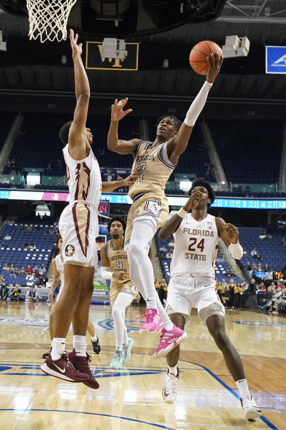 FILE - Georgia Tech guard Miles Kelly (13) drives past Florida State center Naheem McLeod (24) and Chandler Jackson (0) during the second half of an NCAA college basketball game at the Atlantic Coast Conference Tournament in Greensboro, N.C., Tuesday, March 7, 2023. Kelly was the top scorer last season at 14.4 points per game. (AP Photo/Chuck Burton, File)