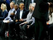 U.S. President Barack Obama takes his seat as he attends an NBA opening night game between the Cleveland Cavaliers and the Chicago Bulls in Chicago October 27, 2015. Earlier Tuesday Obama delivered remarks at an International Association of Chiefs of Police (IACP) conference and attended Democratic Party events in Chicago. REUTERS/Jonathan Ernst