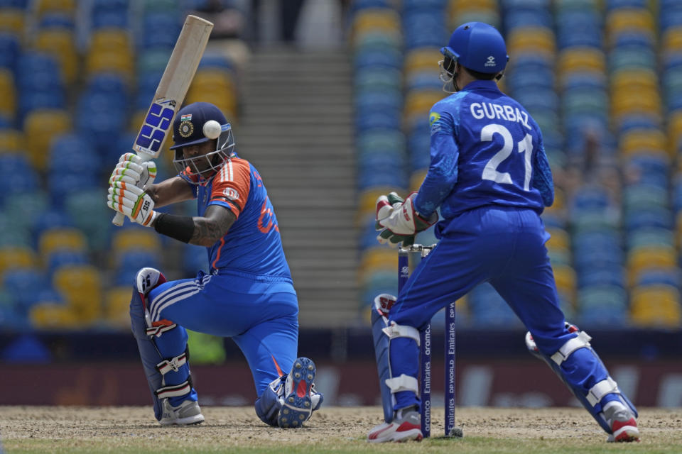 India's Suryakumar Yadav, left, plays a shot during the ICC Men's T20 World Cup cricket match between Afghanistan and India at Kensington Oval in Bridgetown, Barbados, Thursday, June 20, 2024. (AP Photo/Ricardo Mazalan)