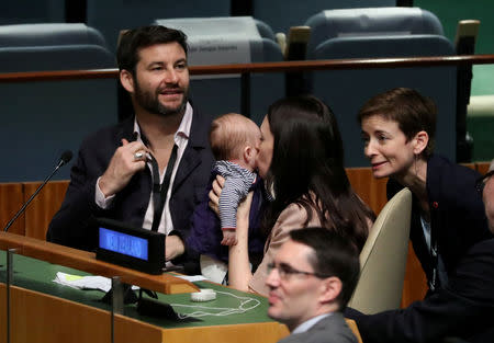 New Zealand Prime Minister Jacinda Ardern kisses her baby Neve after speaking at the Nelson Mandela Peace Summit during the 73rd United Nations General Assembly in New York, U.S., September 24, 2018. REUTERS/Carlo Allegri