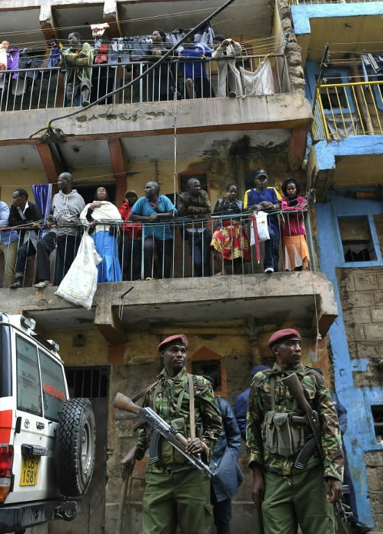 Residents observe rescue efforts of a building collapse in Nairobi on April 30, 2016