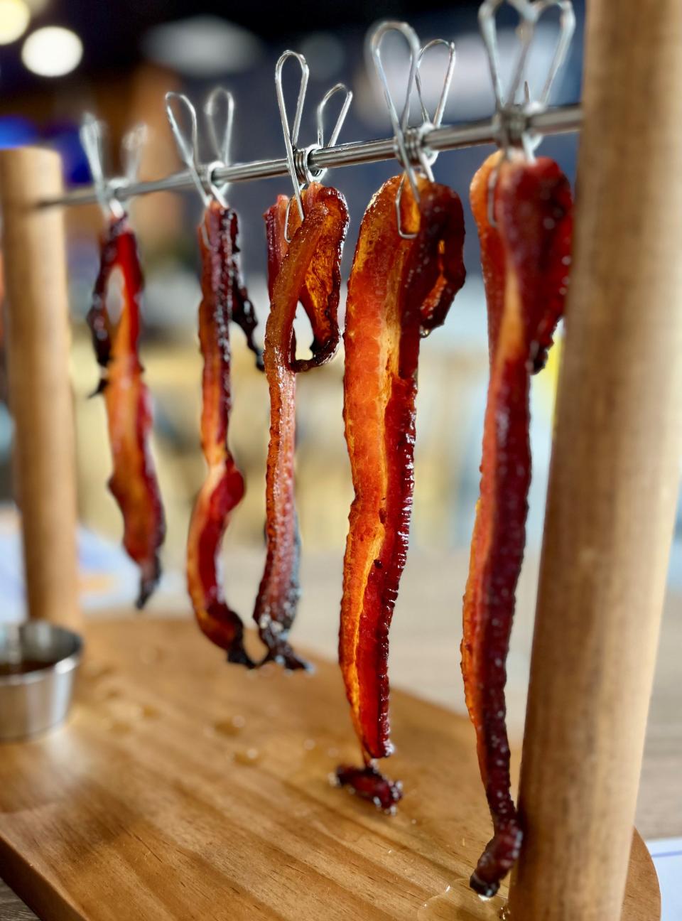 Thick-cut, maple butter, brown sugar and honey-marinated banging bacon is served hanging at BARunch in Cape Coral.