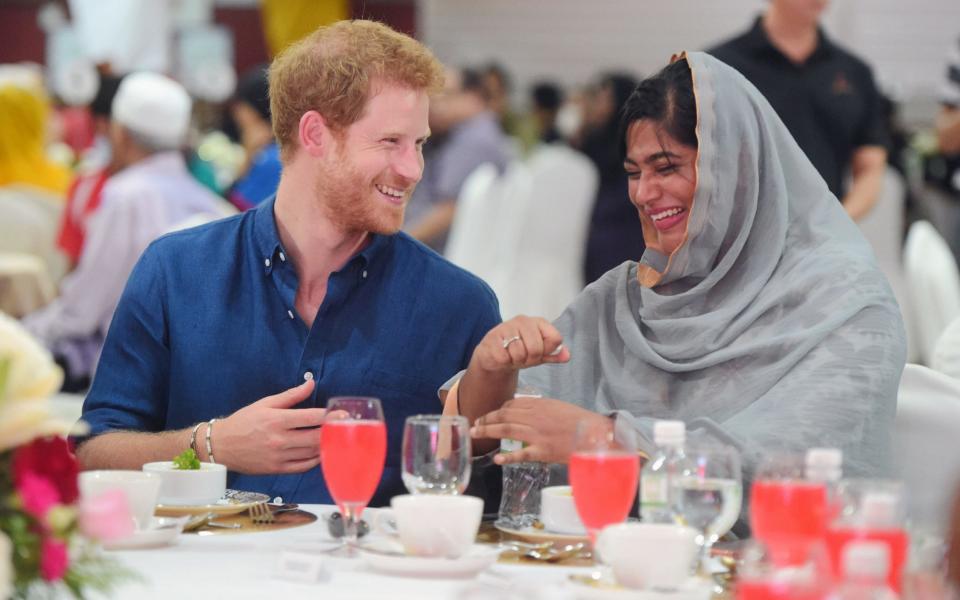 Prince Harry speaks to Nazhath Faheema, a Muslim Youth Ambassador of Peace - Credit:  REUTERS