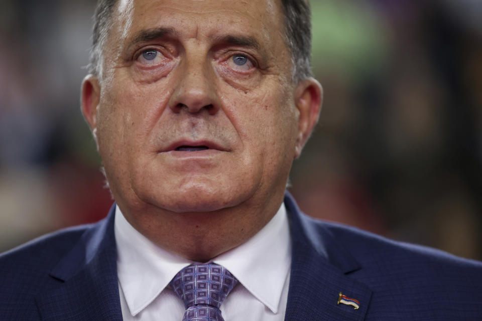 Serb member of the Bosnian Presidency Milorad Dodik listens to the anthem of Alliance of Independent Social Democrats (SNSD) during campaign rally in Istocno Sarajevo, Bosnia, Tuesday, Sept. 27, 2022. Bosnia and Herzegovina will hold a general election on Oct. 2. (AP Photo/Armin Durgut)