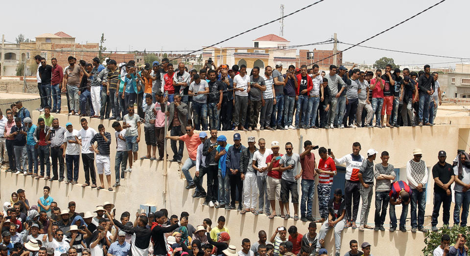 Mourners gathers in front of the house of a dead man hit by a police vehicle in Tatouine