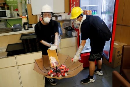 FILE PHOTO: Anti-extradition bill protesters leave money as they grab cans of soda drink inside an empty canteen as as they break into the Legislative Council building during the anniversary of Hong Kong's handover to China in Hong Kong