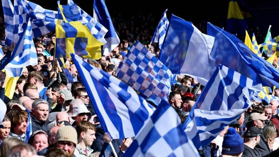 Everton fans wave flags at Goodison Park