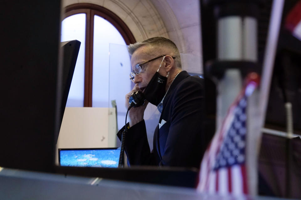 Trader Neil Catania works on the floor of the New York Stock Exchange, Friday, July 23, 2021. Stocks rose in early trading on Wall Street Friday and put the major indexes on track for a strong finish in a week that opened with a stumble. (AP Photo/Richard Drew)