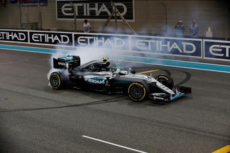 Formula One - F1 - Abu Dhabi Grand Prix - Yas Marina Circuit, Abu Dhabi, United Arab Emirates - 27/11/2016 - Mercedes' Formula One driver, Nico Rosberg of Germany celebrates after winning the Formula One 2016 Drivers' World Championship . REUTERS/Ahmed Jadallah/Files