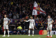 Liverpool's Fabinho, Joel Matip and James Milner, from left to right, react after Barcelona scored their third goal during the Champions League semifinal, first leg, soccer match between FC Barcelona and Liverpool at the Camp Nou stadium in Barcelona Spain, Wednesday, May 1, 2019. (AP Photo/Joan Monfort)