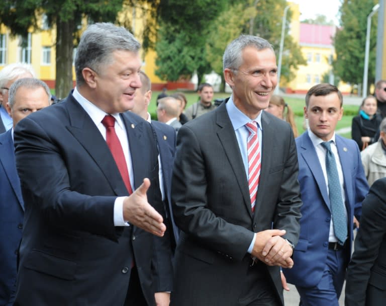 Ukraine's President Petro Poroshenko (L) and NATO chief Jens Stoltenberg (C) attend an opening ceremony at the Yavoriv training ground on September 21, 2015