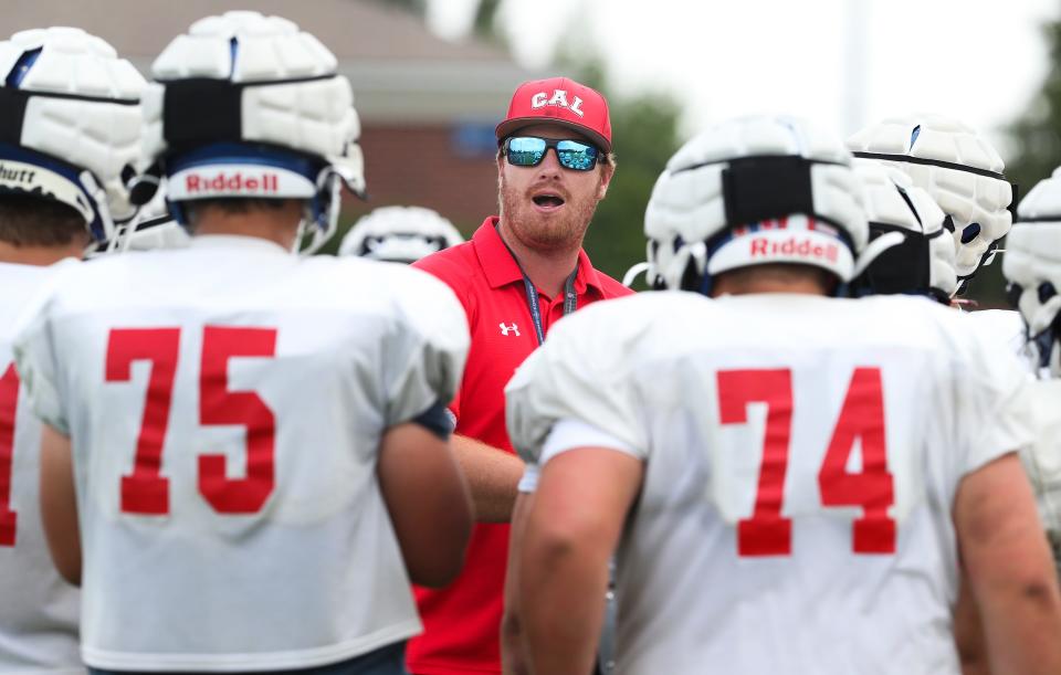 Christian Academy of Louisville head coach Hunter Cantwell, center, instructs players during practice at the school in Louisville, Ky. on Aug. 5, 2021.  