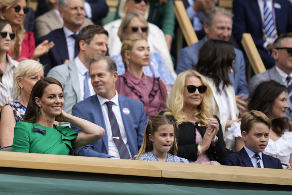Kate, Princess of Wales, Princess Charlotte and Prince George sit in the Royal Box on Centre Court for the final of the men's singles between Spain's Carlos Alcaraz and Serbia's Novak Djokovic on day fourteen of the Wimbledon tennis championships in London, Sunday, July 16, 2023. (AP Photo/Kirsty Wigglesworth)