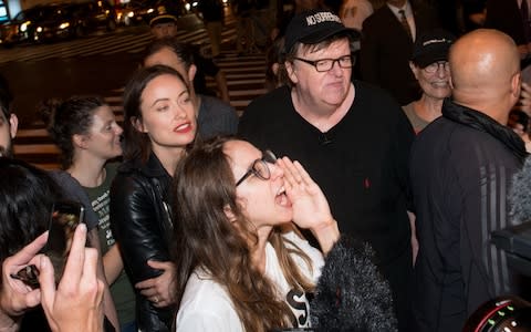 Zoe Kazan and Olivia Wilde join Michael Moore as he leads his Broadway audience to Trump Tower  - Credit: Getty