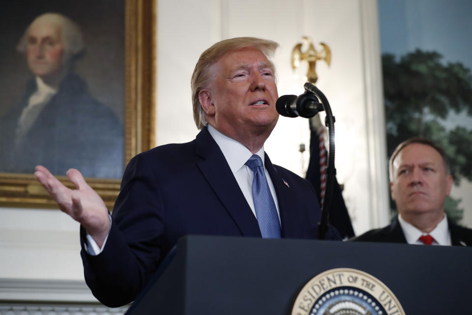 President Donald Trump, accompanied by Secretary of State Mike Pompeo, speaks Wednesday, Oct. 23, 2019, in the Diplomatic Room of the White House in Washington. (AP Photo/Jacquelyn Martin)