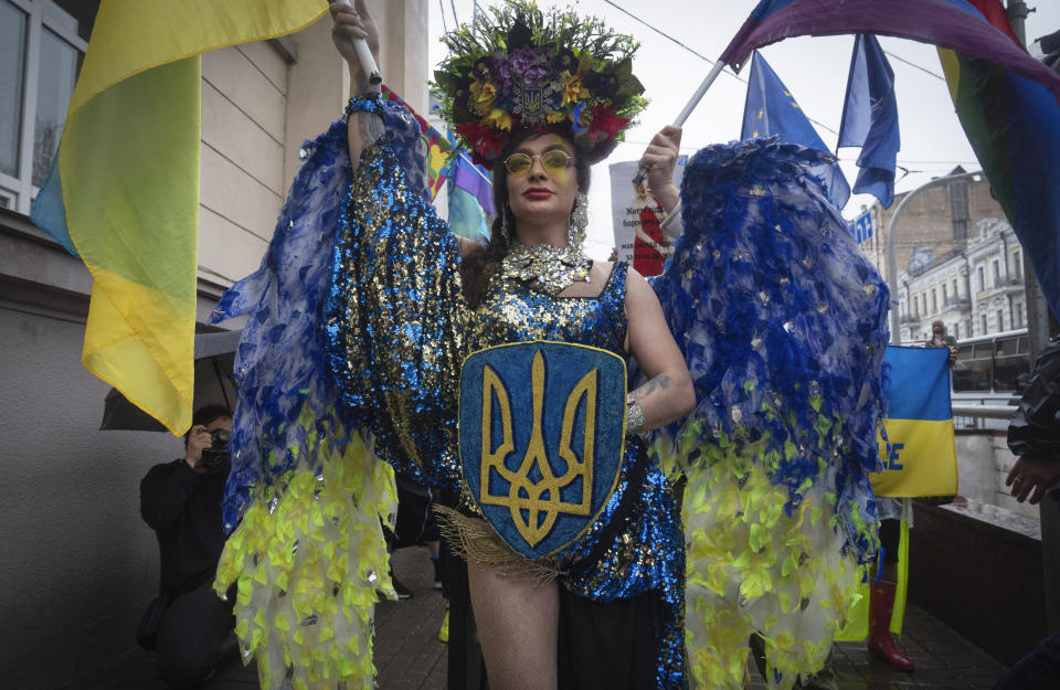 People take part in the annual Gay Pride parade, under the protection of riot police in Kyiv, Ukraine, Sunday, June 16, 2024. Several hundred LGBT Ukrainian servicemen and other protesters joined the pride march in central Kyiv Sunday seeking legal reforms to allow people in same-sex partnerships to take medical decisions for wounded soldiers and bury victims of the war that extended across Ukraine more than two years ago. (AP Photo/Efrem Lukatsky)