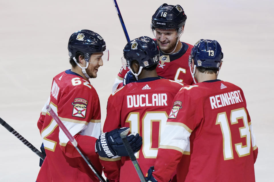 Florida Panthers teammates congratulate left wing Anthony Duclair (10) after he scored a goal during the second period at an NHL preseason second doubleheader hockey game against the Nashville Predators, Sunday, Sept. 26, 2021, in Sunrise, Fla. (AP Photo/Marta Lavandier)