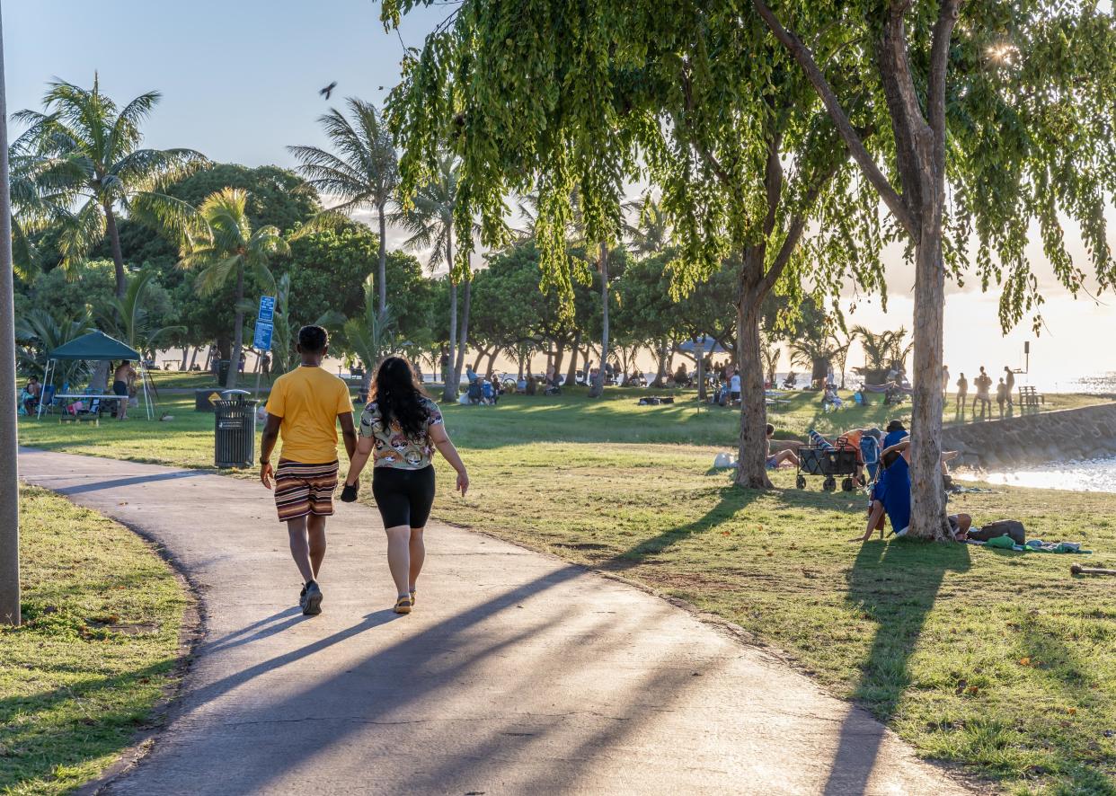 People enjoy a relaxing day at Ala Moana Beach Park. 