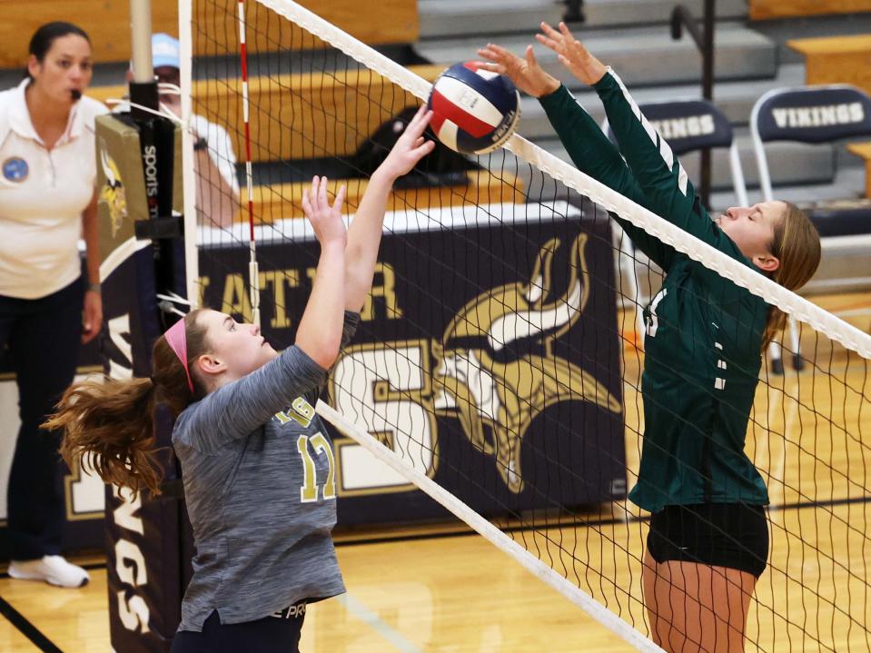 Abington's Hannah Tirrell blocks the volleyball on East Bridgewater's Paige Pavidis during a game on Wednesday, Oct. 13, 2022.