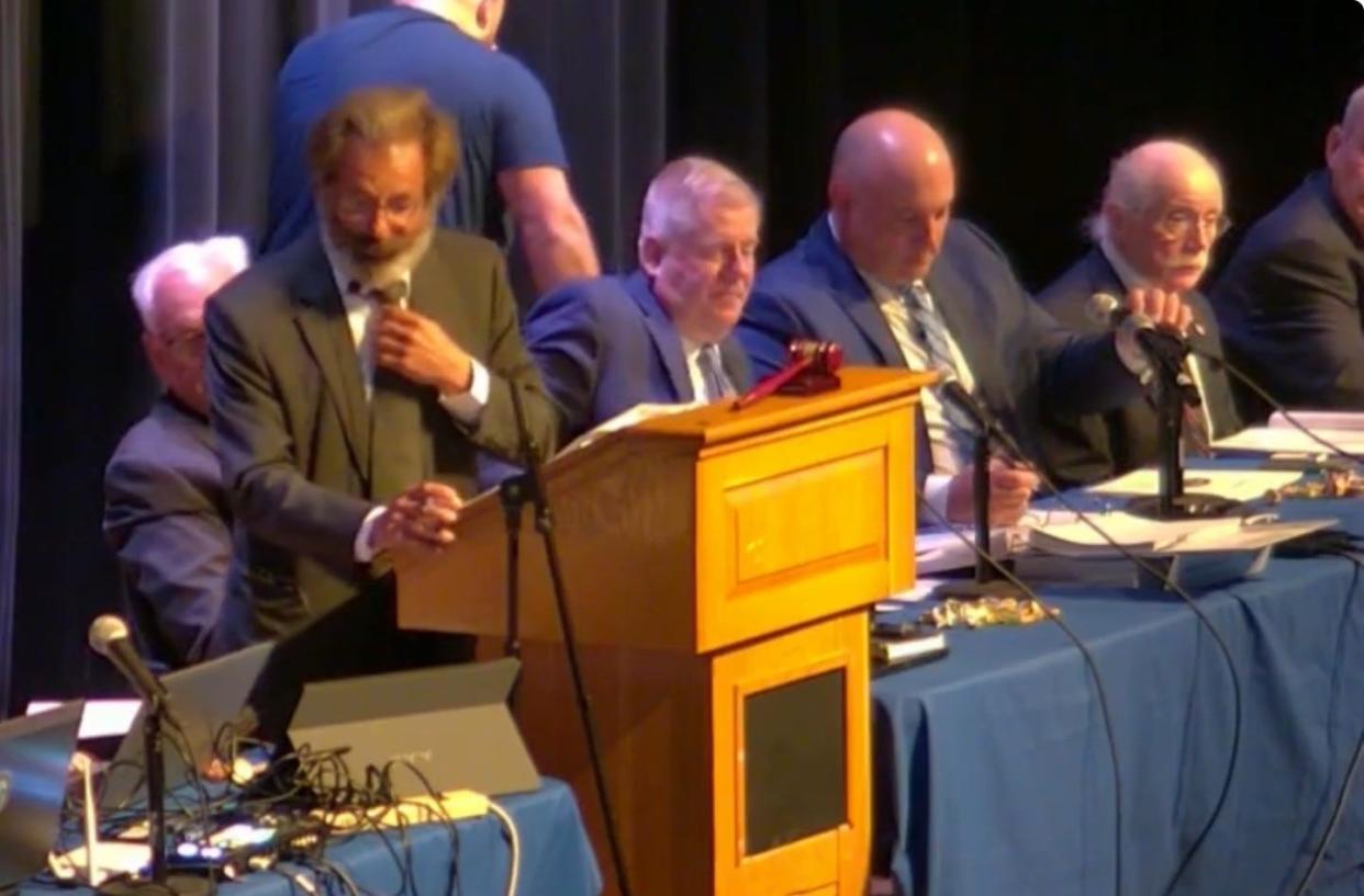 Sandwich moderator Garry Blank calls on voters to use their clickers to register their votes during Monday's annual town meeting. It was the first time the devices were used to tally votes.