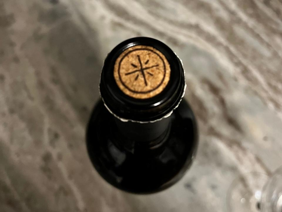 An overhead shot shows a star-like design on the cork of a wine bottle.