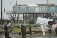 Flooding surrounds damaged homes Friday, Aug. 28, 2020, in Cameron, La., after Hurricane Laura moved through the area Thursday. (AP Photo/David J. Phillip)