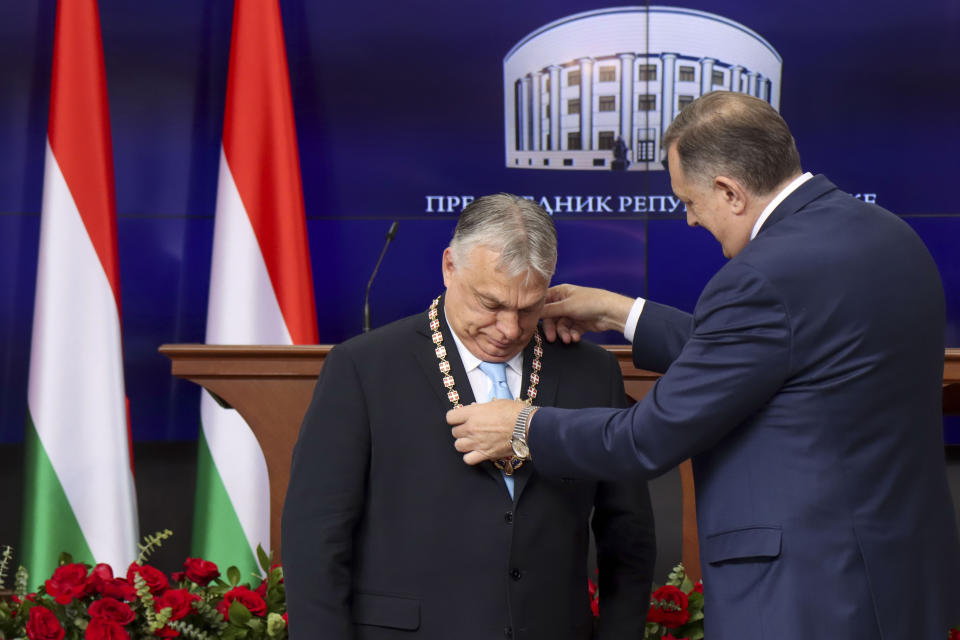 In this photograph made available by the Republika Srpska Presidential Press Service, Hungary's Prime Minister Viktor Orban, left, receives the Order of Republika Srpska from Bosnian Serb leader Milorad Dodik during his visit in Banja Luka, Bosnia, Friday, April 5, 2024. Orban is on a two-day visit to Bosnia and Herzegovina. (Republika Srpska Presidential Press Service via AP)