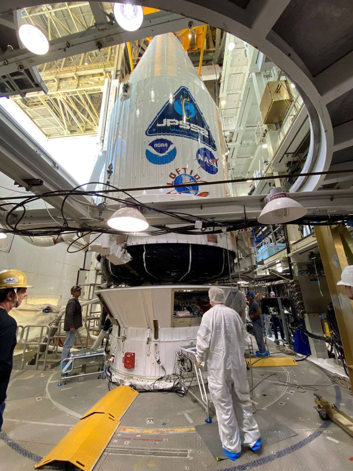 Tucked into the payload fairing or rocket nose cone, a weather observatory and technology demonstrator are mounted atop its ride to space aboard an Atlas V rocket from Vandenberg Space Force Base near Lompoc.