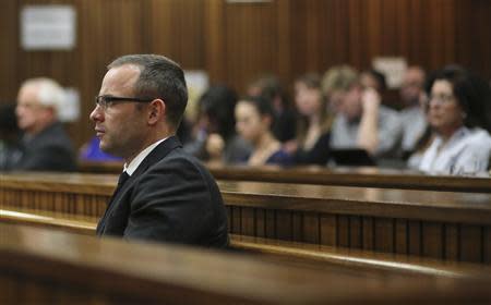 Oscar Pistorius sits in the dock during his trial in the North Gauteng High Court in Pretoria, May 13, 2014. REUTERS/Themba Hadebe/Pool