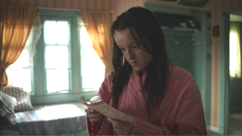 Ellie reading the instructions for a menstrual cup