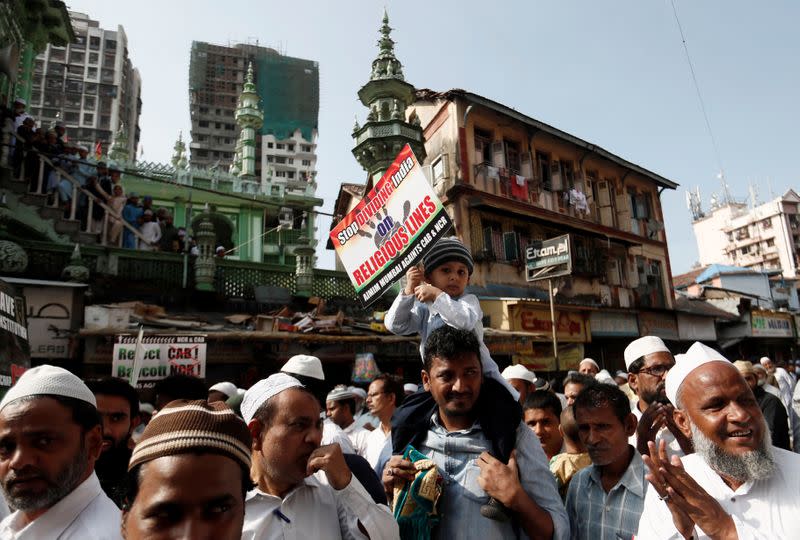 A boy holds a placard during a protest against the Citizenship Amendment Bill in Mumbai