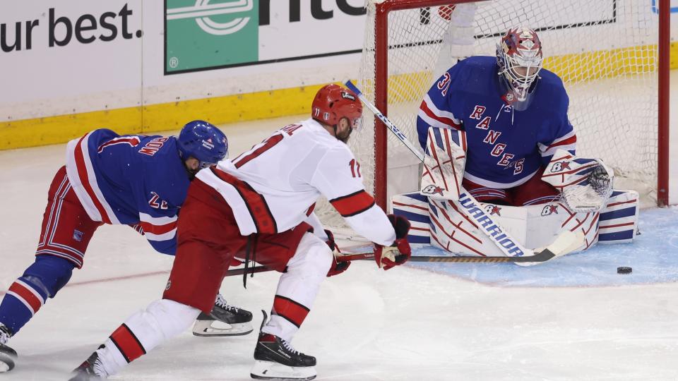 May 7, 2024; New York, New York, USA; New York Rangers goaltender Igor Shesterkin (31) makes a save against Carolina Hurricanes center Jordan Staal (11) in front of Rangers center Barclay Goodrow (21) during the second overtime of game two of the second round of the 2024 Stanley Cup Playoffs at Madison Square Garden.
