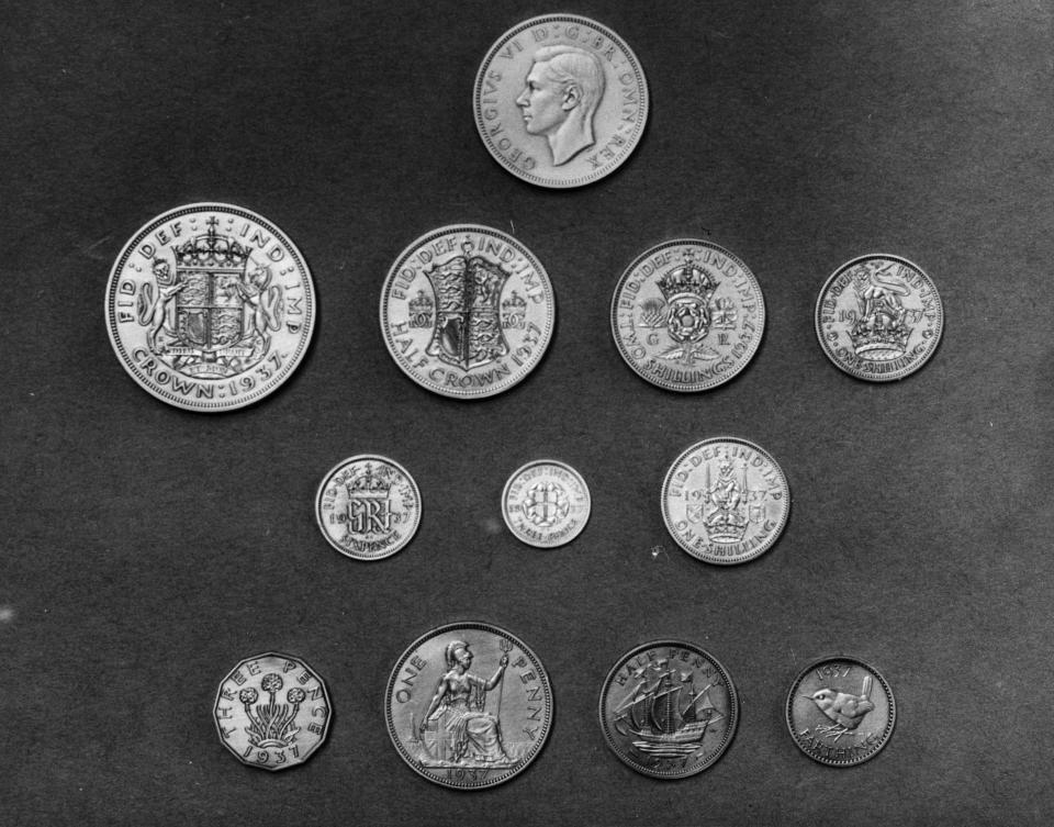 1937:  A close-up of a set of the new English coins minted for the reign of King George VI, including a crown, a half crown, a two shilling piece, a shilling, a sixpence, a three pence or thrupenny bit, a penny, a half penny or ha'penny and a farthing.  (Photo by Central Press/Getty Images)